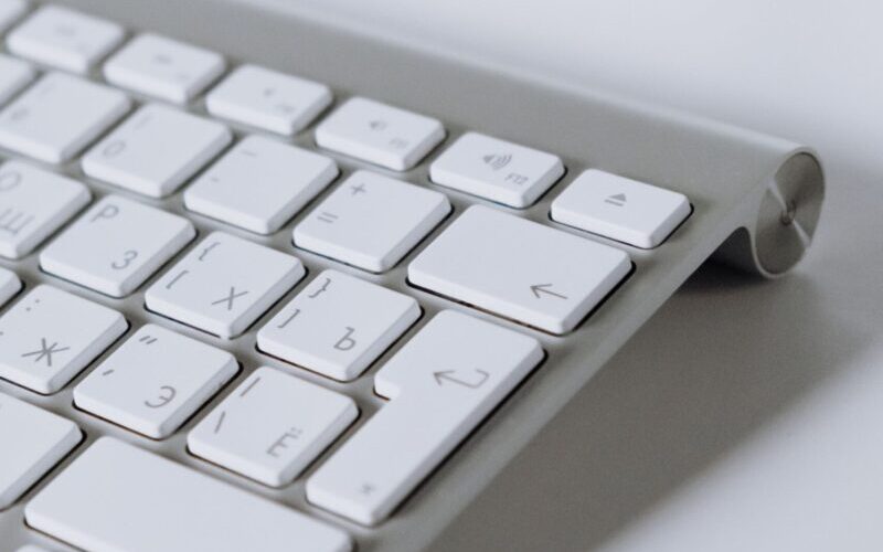 Close-up of a white modern wireless keyboard, perfect for digital and office work settings.
